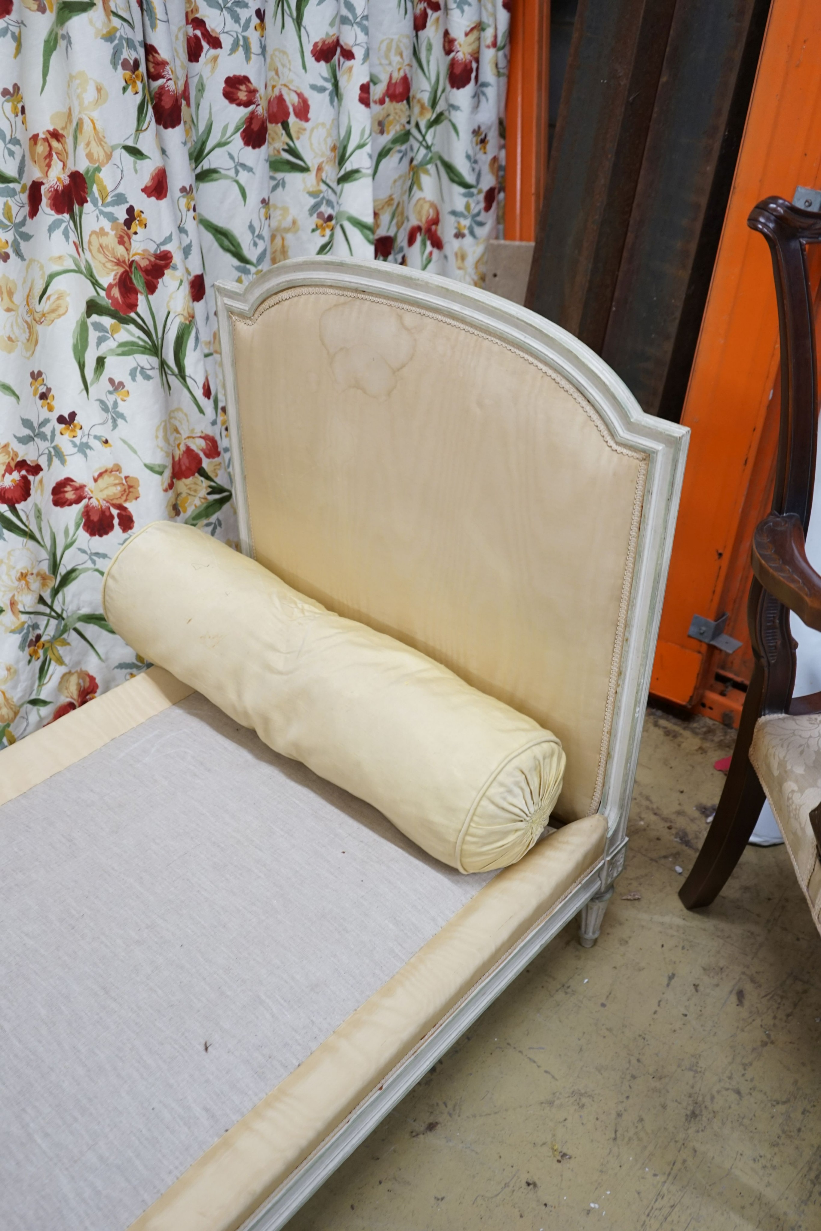 A Louis XVI style yellow painted upholstered French daybed, width 198cm, depth 69cm, height 88cm